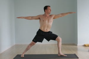man practicing hot yoga
