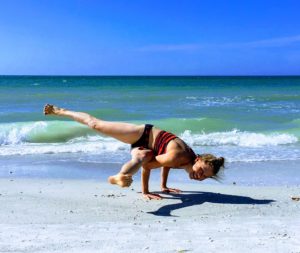 woman doing yoga pose at the beach