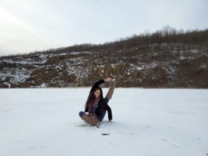 woman doing yoga pose in the snow