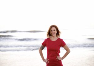 woman in red dress, ocean in the background