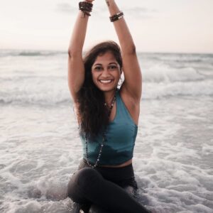 woman in ocean doing yoga pose
